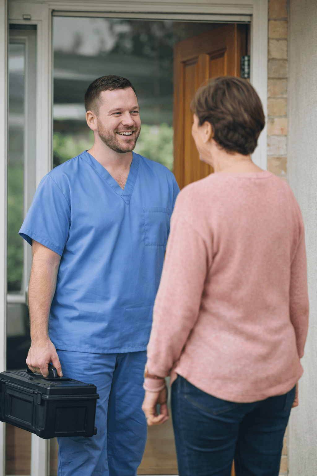 Podiatrist arriving for a home visit with an older client