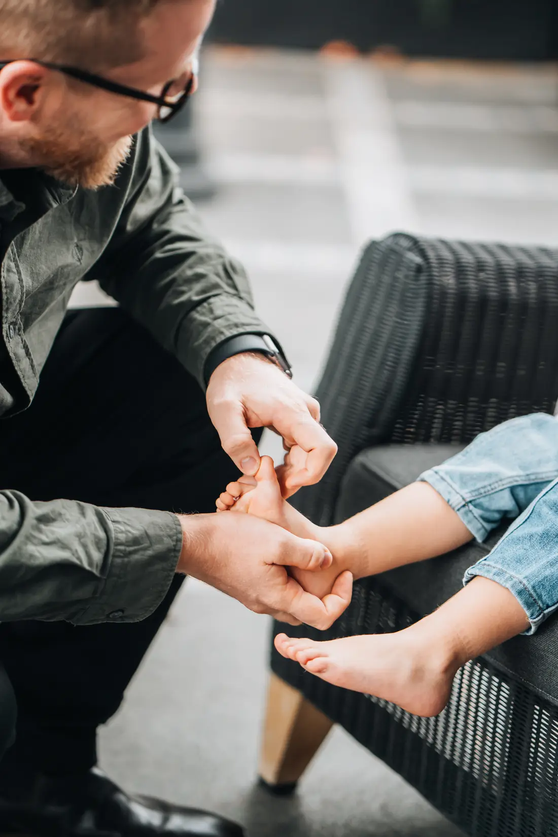 Podiatrist assessing a child's foot and lower limb