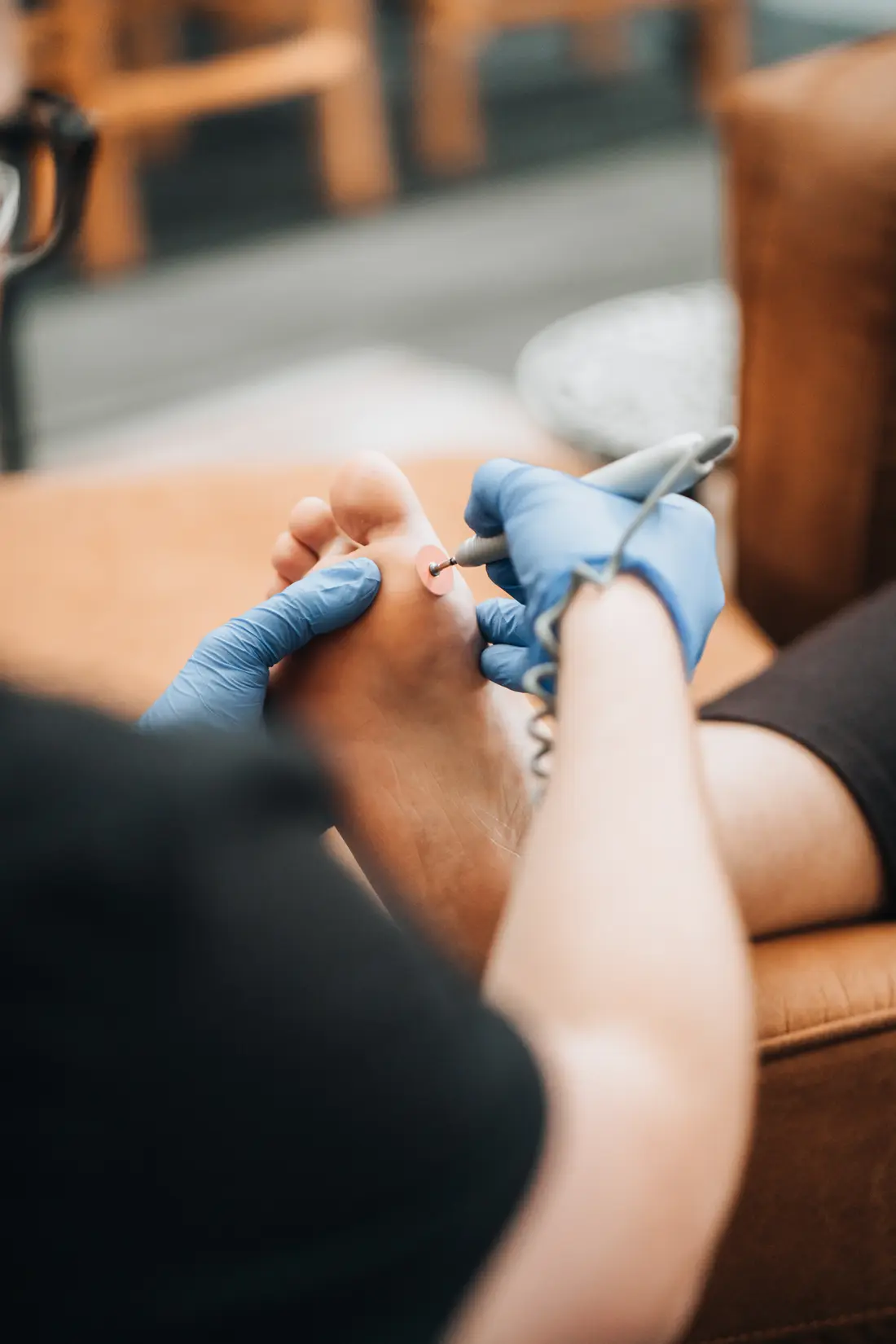 Podiatrist performing diabetic foot care with a sanding drill